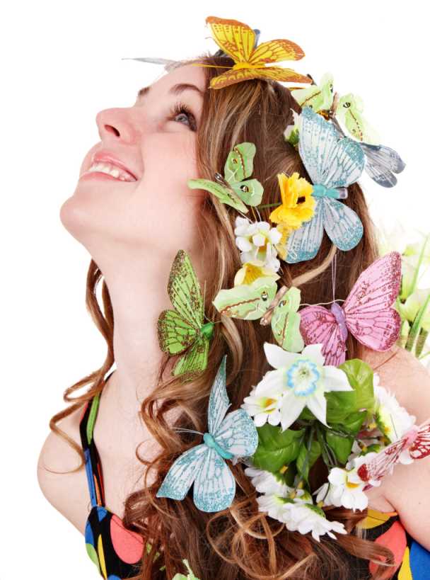 Girl with butterfly and flower on head. Spring hair.